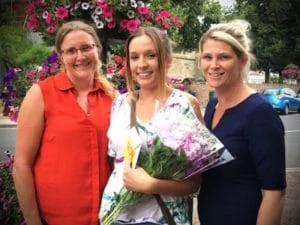 Kelly is presented with flowers