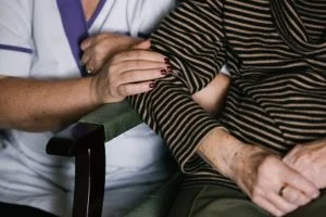 An elderly lady with her regular carer