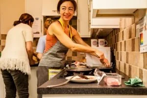 An assistant cooking at home