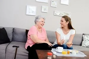 Lady with carer at breakfast