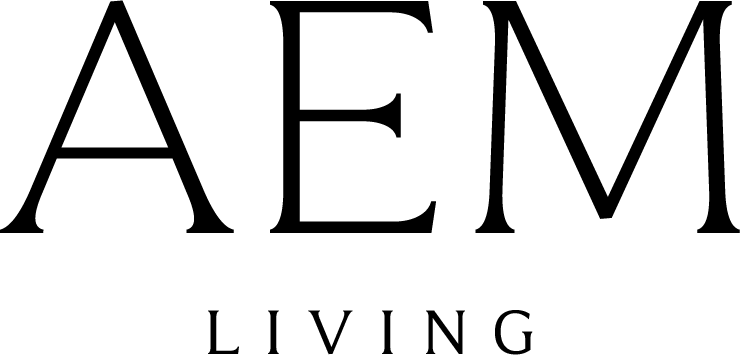 The image shows the text AEM in large, elegant font above the word LIVING in smaller, spaced-out letters on a light background.