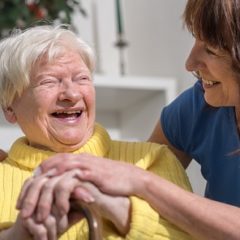 Carer and elderly lady laughing