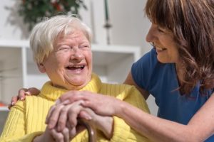 Carer and elderly lady laughing