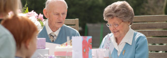 An elderly couple celebrating a birthday at home