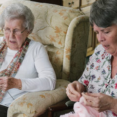 Dorothy knitting with her live-in carer, Magda