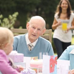 An elderly couple celebrating a birthday at home
