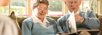 Ann elderly couple looking through a photo album