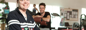 A customer in the gym with his live-in carer