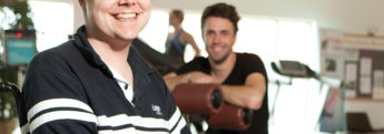 A customer at the gym with his live-in carer