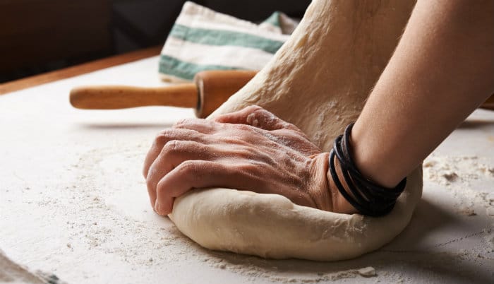 kneading dough with both hands