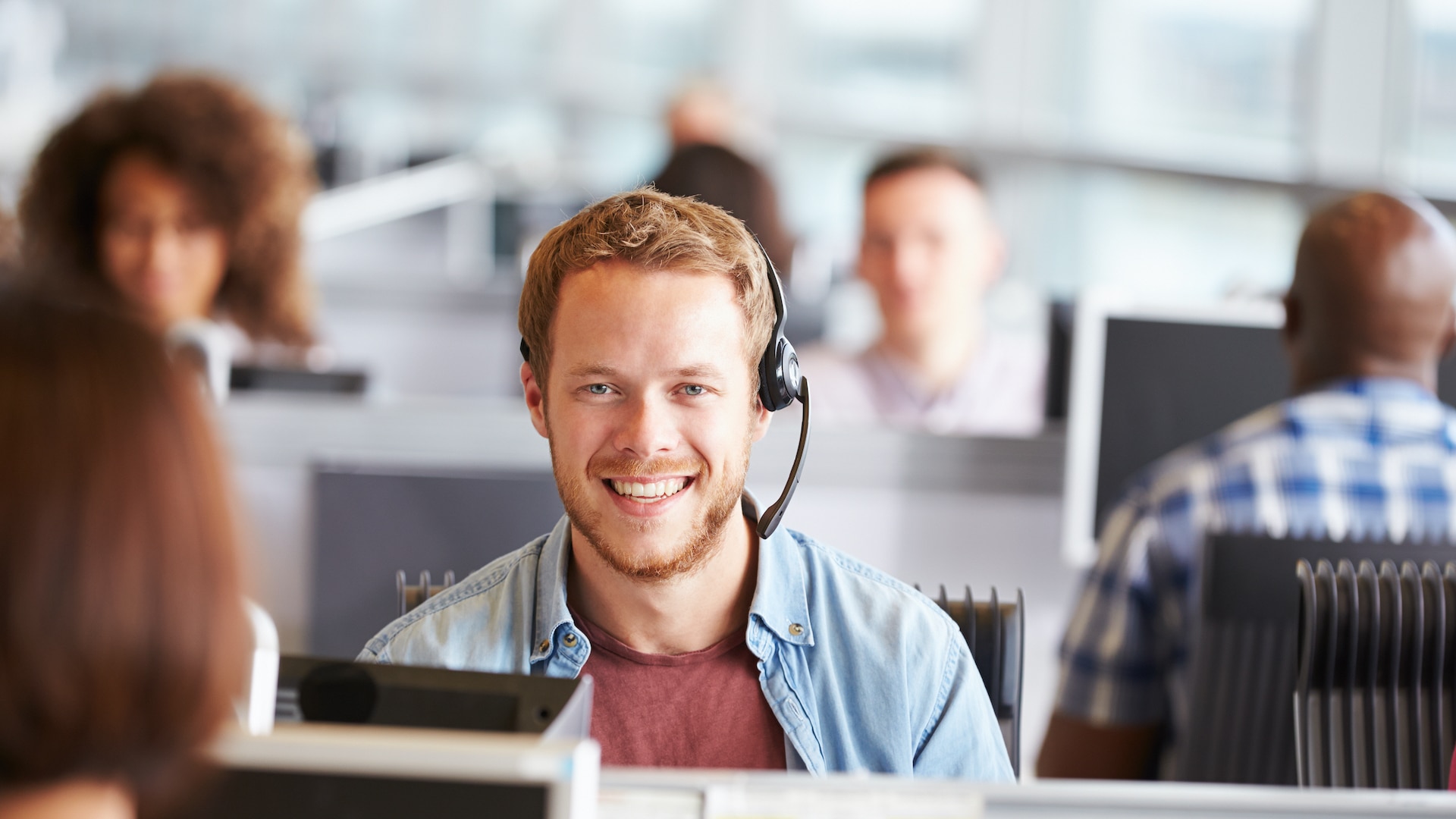 Man in call centre smiling